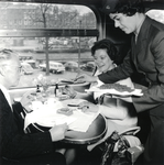 168156 Afbeelding van een stewardess van Wagons-Lits tijdens het serveren van lunch in een electrisch treinstel mat. ...
